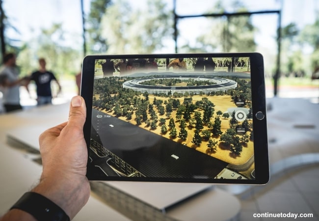 human hand holding display monitor of augmented reality