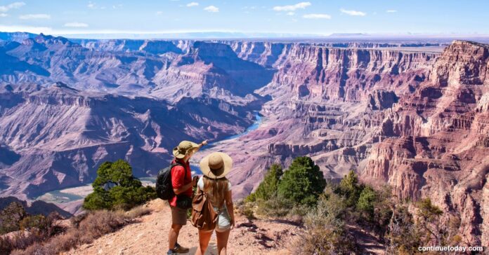 Two people enjoying the view of mountain