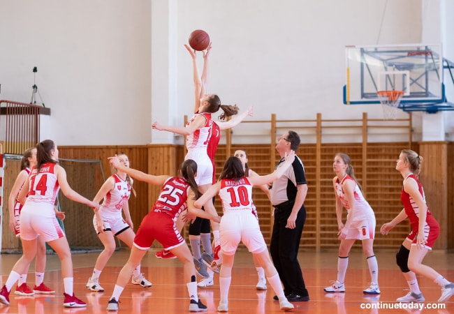 A group of girl playing basketball