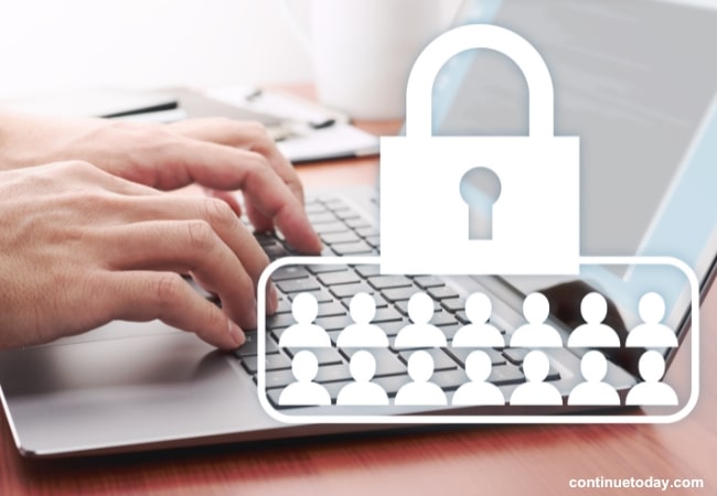 Individual pressing the laptop with security system 