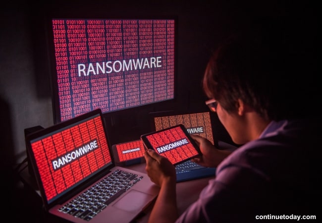 boy working on ransomware attacks on different devices