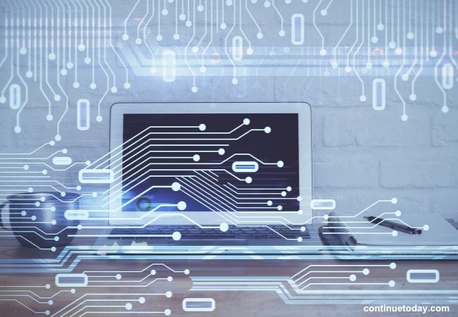 laptop surrounded with cup and files indicating Edge Computing powerful data transferring feature