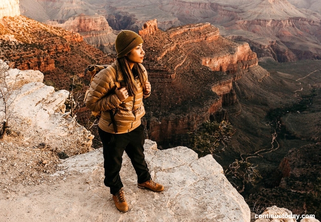 A girl standing on a hill at Grand Canyon