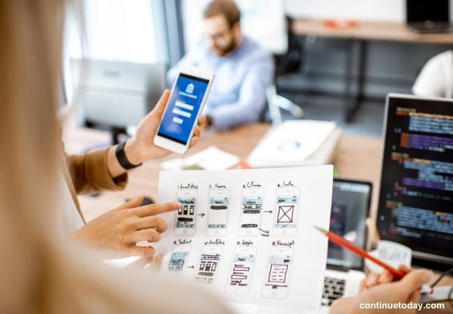 human hand holding paper for mobile app development 